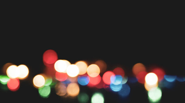Abstract background image of beautiful multicolored bokeh made by blurry lenses.