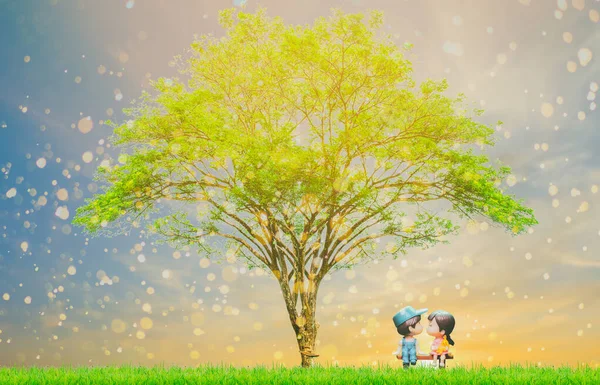 Couple dolls are kissing in love on Valentine\'s Day under a beautiful romantic tree.
