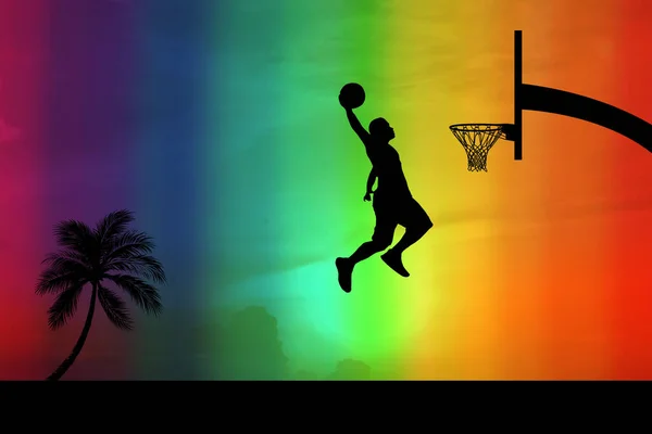 Basketball players jumping dunk silhouettes on a beautiful outdoor basketball court in the evening.
