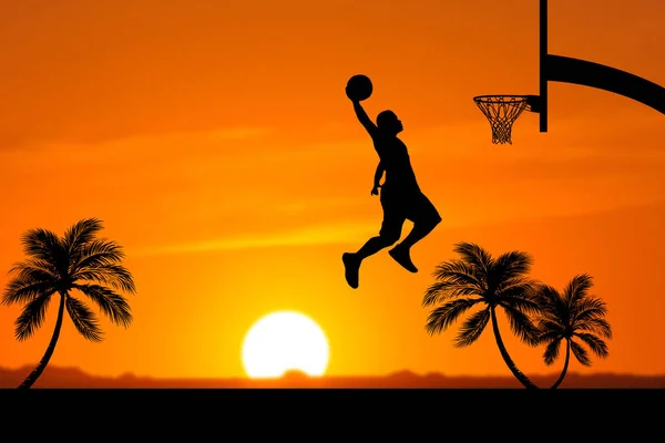 Basketball players jumping dunk silhouettes on a beautiful outdoor basketball court in the evening.