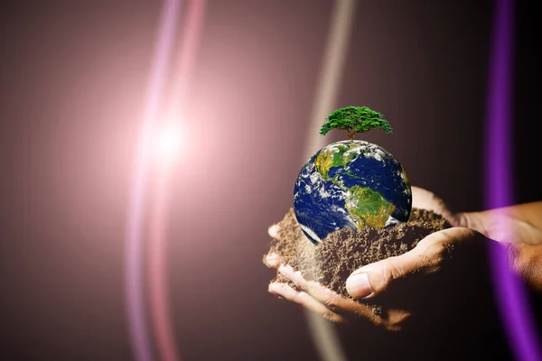 hands holding the earth where the earth is heated by the sun causing global warming. element of the picture is decorated by NASA