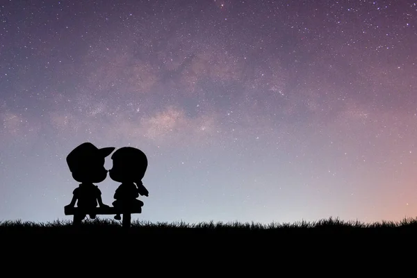 silhouette of couple with a star on background of starry sky