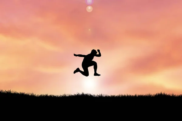 丘の上をジャンプする男のシルエットを背景に夕焼け空 — ストック写真