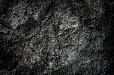 Arkaplan olarak soyut desenli koyu taş duvar 