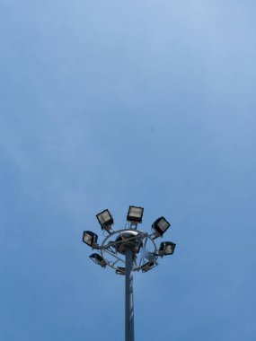 Mavi gökyüzünde projektörleri olan sokak lambası inşaatı