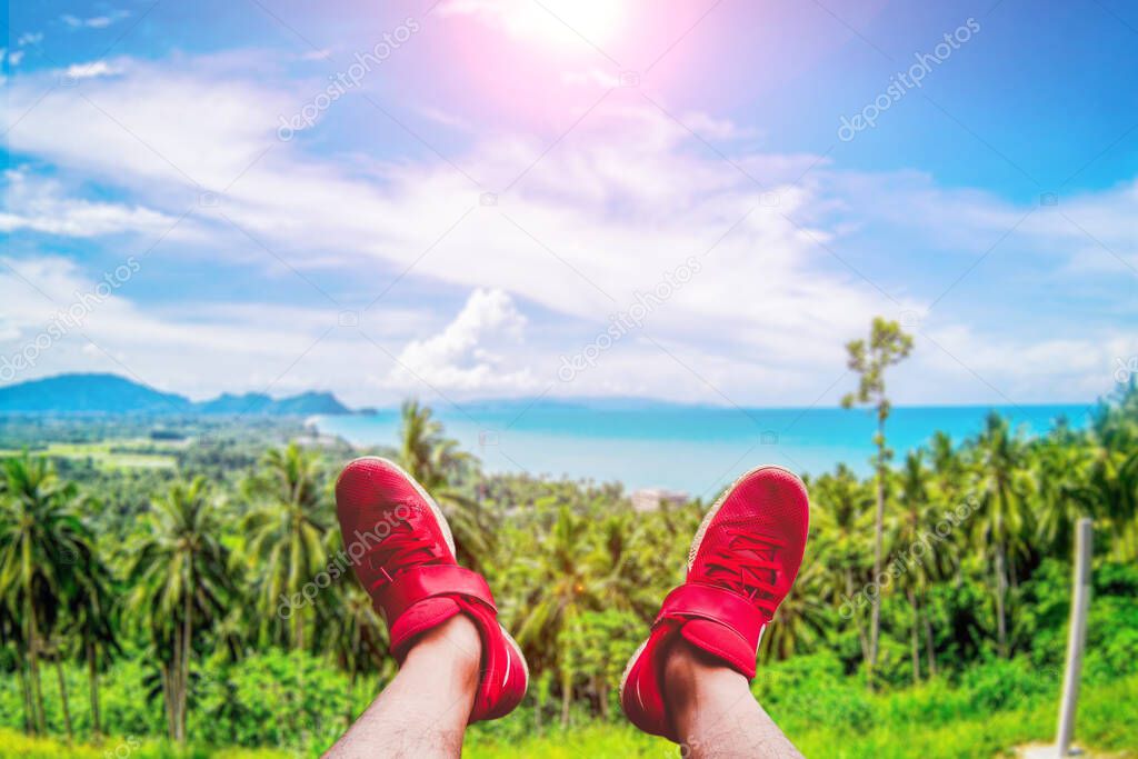 The red tourist shoes happily extended into the beautiful scenery. Travel ideas after the Covid-19 crisis