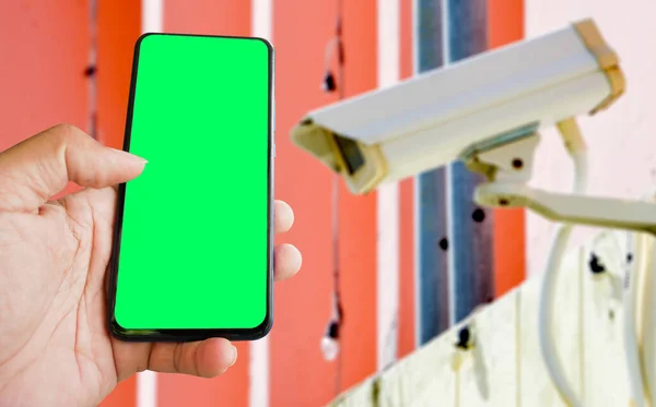 cctv and mobile with green blank screen or copy space to put the desired content in your project. cctv on the wall for security.
