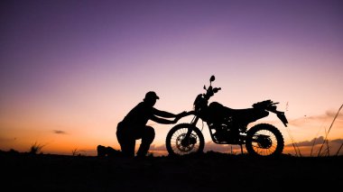 Akşamları motosikletle, motosikletle ya da motokrosla macera yaşayan turistlerin silueti. - Evet. seyahat ve macera kavramı