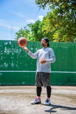 26 Haziran 2021 'de COVID-19 krizi sırasında dışarıda basketbol oynayarak egzersiz yapan adam, Surat Thani, Tayland.