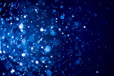 Bulanık lensten mavi bokeh 'in soyut arkaplan resmi. arkaplan kullanımı