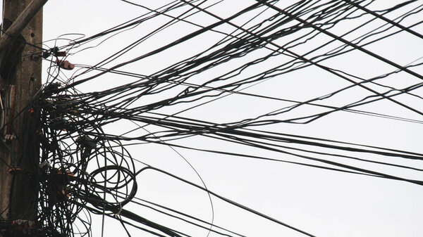 Messy electrical and communication cables. The concept of insecurity and carelessness