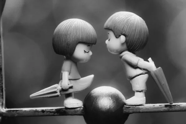 Black and white picture of a couple dolls as a background in your project