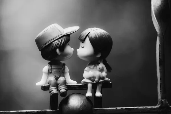 Black and white picture of a couple dolls as a background in your project