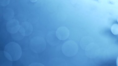 Mavi bokeh parçacıkları, toz gradyan soyut arkaplanı ödüllendirir. Mavi arkaplanda uzayda fütürist ışıltı. 