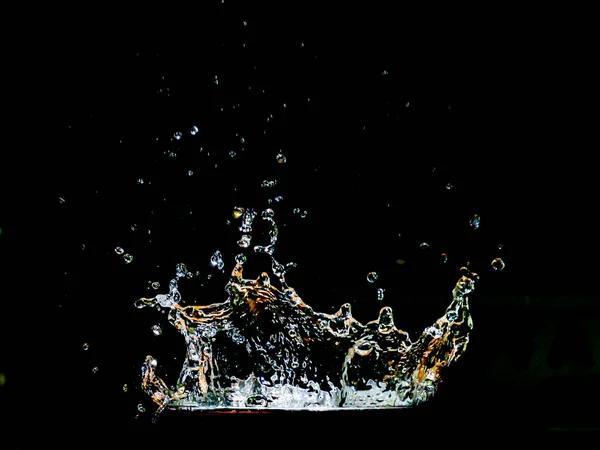 Scattered water on a black background. splashing water on black background for use in the project