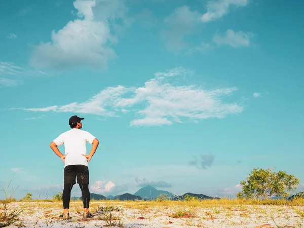 Asian man walking in sand on a nice day. Exercise and relaxation concepts