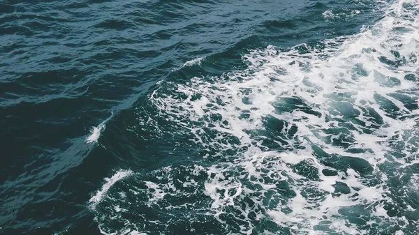 Derin mavi denizde beyaz köpük yaratan okyanus dalgalarının hava görüntüsü doğanın dinamik güzelliğini gözler önüne seriyor..