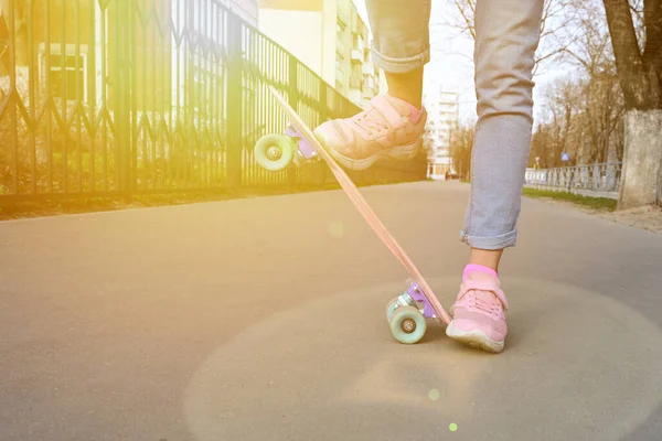 Close Benen Meisje Skateboarder Blauwe Jeans Roze Sneakers Rijden Roze — Stockfoto