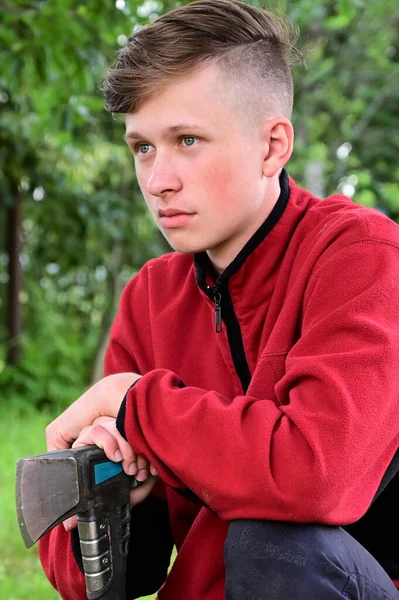 Portrait Young Serious Man Sitting Forest Leaning His Hands Axe — Stock Photo, Image