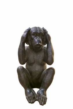 Bir maymun heykeli sade bir arka planda oturur. Şeklin kulaklarını kapatan elleri ve düşünceli bir ifadesi var. Koyu malzemeden yapılmıştır ve ayrıntılı özelliklerini gösterir..