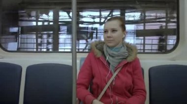 Kız dinler müzik metro ve gülümseyen