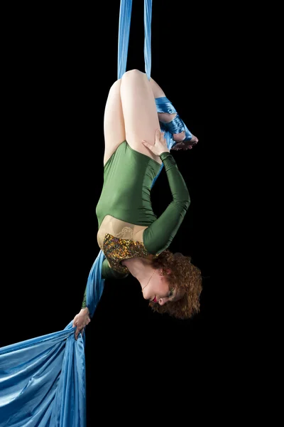 Молодая женщина делает упражнения на воздушный шелк — стоковое фото