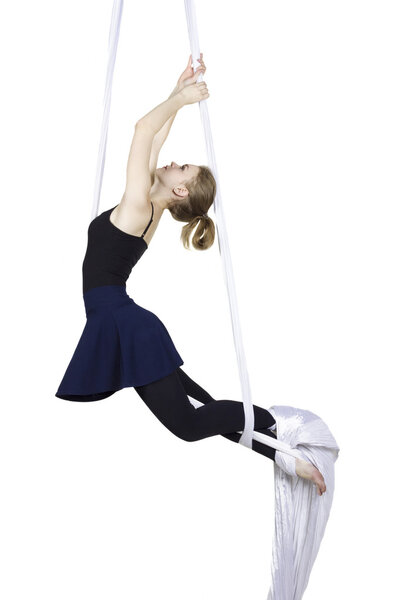 Athletic woman doing some tricks on silks 