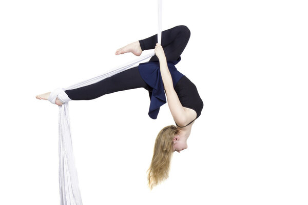 Athletic woman doing some tricks on silks 