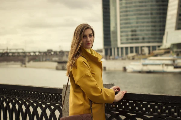 Beautiful young woman stand on the high-rise buildings backround