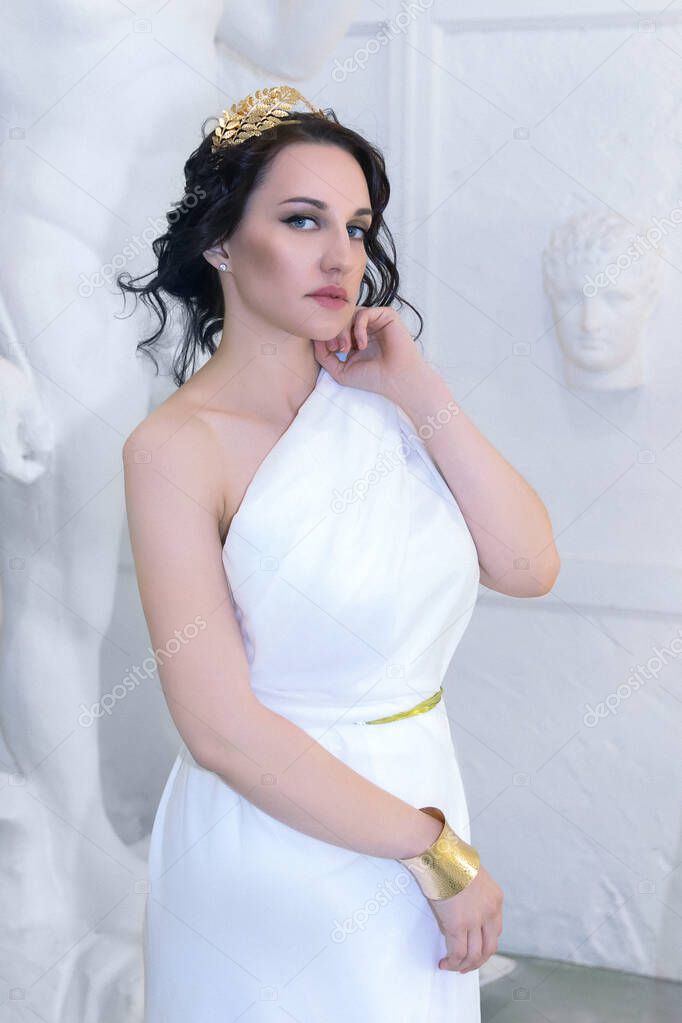 Beautiful Greek goddess woman closeup on the white ancient ruins background.