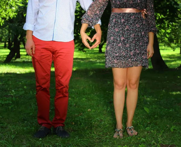 Pasangan muda menyilangkan lengannya dalam bentuk hati — Stok Foto