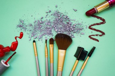 Kompozisyon makyaj gölgeler ve tırnak cilası turkuaz bir arka plan üzerinde bir dizi