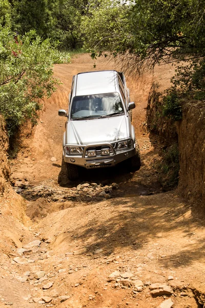 Four-wheel drive vehicle Toyota Hilux  is doing off-road trail. — Stock Photo, Image