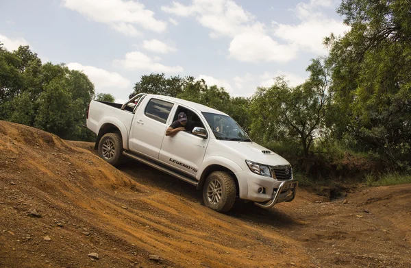 Four-wheel drive vehicle Toyota Hilux Legend 45 is doing of- road trail. — Stock Photo, Image