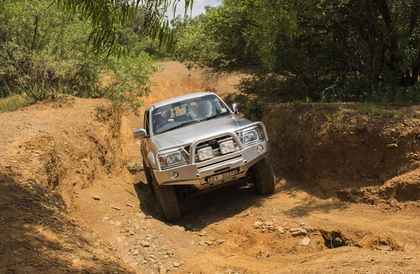 Four-wheel drive vehicle Toyota Hilux is doing off-road. — Stock Photo, Image