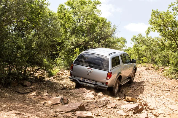 Four-wheel drive vehicle Mitsubishi Triton is doing off-road trail. — Stock Photo, Image