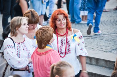 Red-haired girl in national costume. A girl in an embroidered shirt with red beads on her chest with a surprised expression on her face. The twentieth anniversary of Independence of Ukraine. August 24, 2011. Ukraine, Kiev clipart