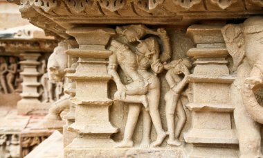 Scene love. The frescoes of the temple Lakshmana displayed erotic scenes man, woman embracing. The bas-reliefs and murals in the Temple of Love in India, 02 September 2006: The temples at Khajuraho clipart