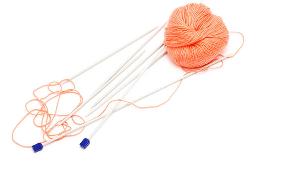 knitting needles and a skein of wool yarn