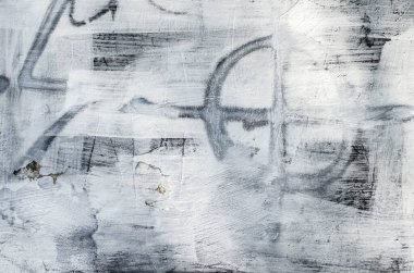 Torn old plaster background. Symbol of the cross in a circle. Grunge cracked concrete wall. Wall texture with cracked plaster and whitewash.