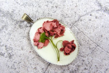 Pendant with flowers in epoxy resin. Women's handmade jewelry clipart