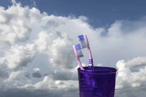 Pair Toothbrushes Glass Front Sky Clouds — Stock Photo, Image