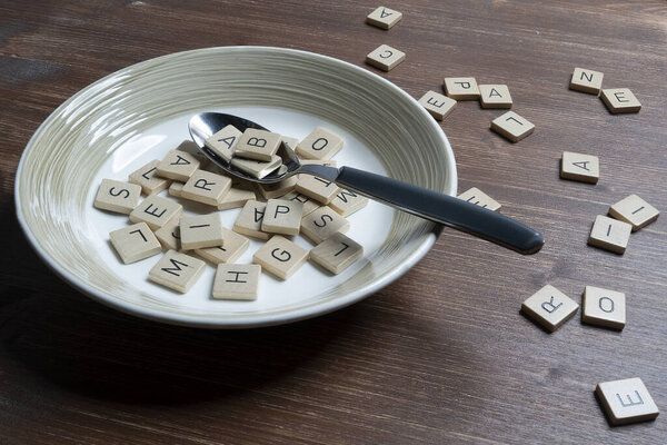 a plate full of letters on a wooden table
