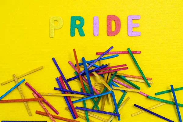 Multicolored Word Pride Some Colored Sticks Yellow Surface — 스톡 사진