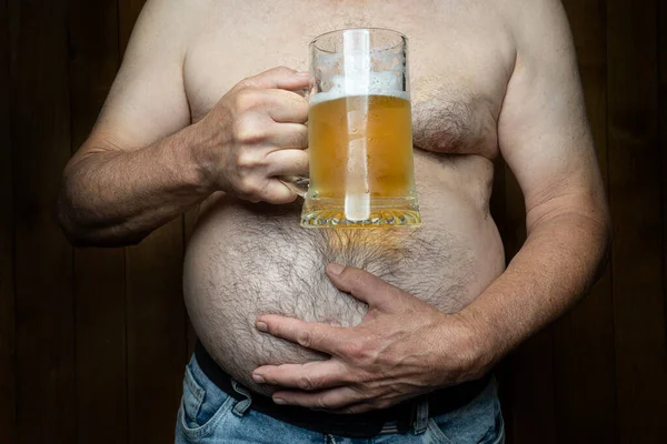 a man with a big belly with a mug of beer in his hand