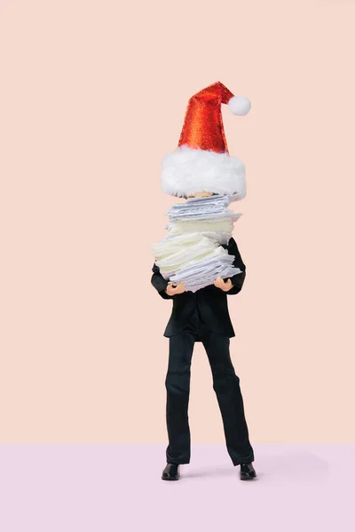 male businessman wearing santa claus hat  holding a stack of papers, all hands on deck concept