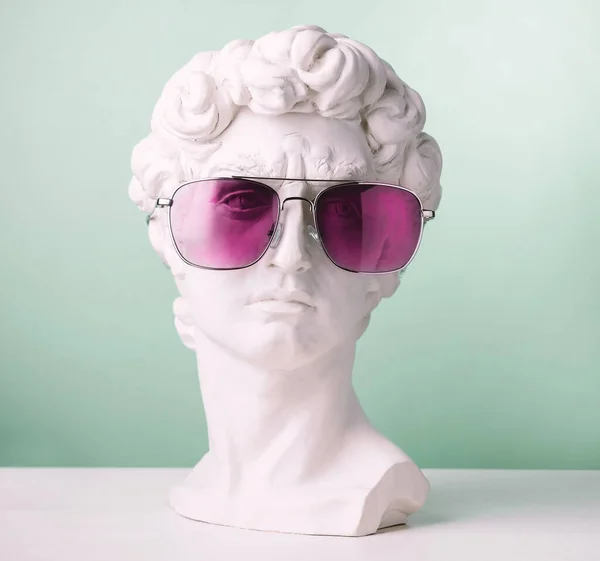 Plaster Statue Head Green Background Wearing Pink Sunglasses — Stock Photo, Image