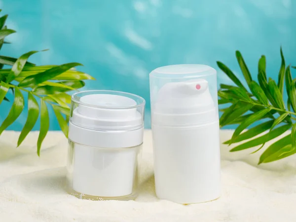 Mock up white blank cosmetics jar on a summer beach. Summer skin care concept.