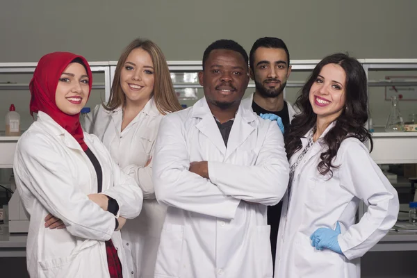 Group of young medical workers are working in lab as lab technic