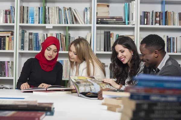 Group of students studying at university library — Stock Photo, Image